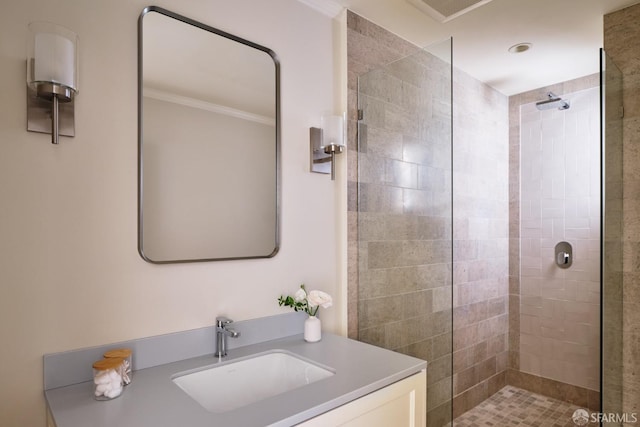 full bathroom with vanity, ornamental molding, and tiled shower