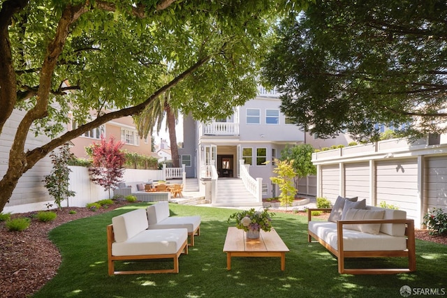 rear view of property featuring an outdoor living space, fence, a yard, and a patio area