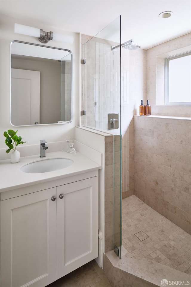 full bathroom featuring vanity, a shower stall, and tile patterned flooring