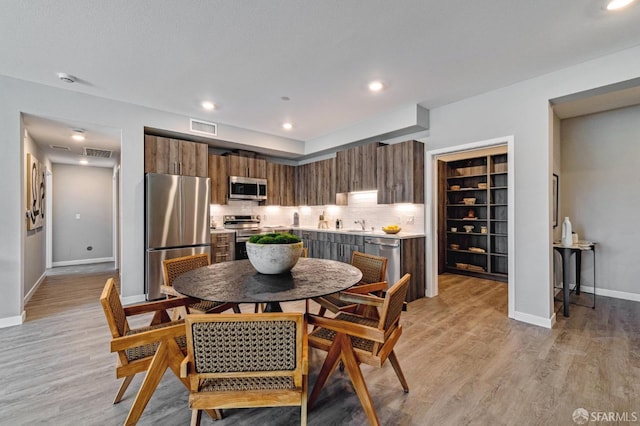 dining room featuring light hardwood / wood-style flooring