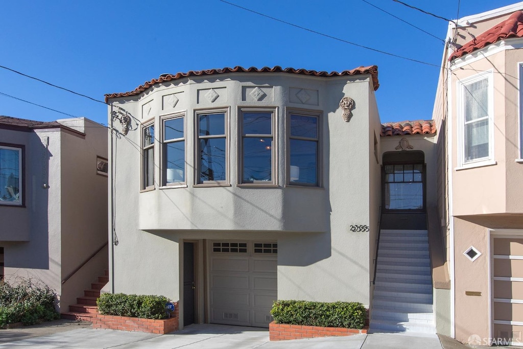 mediterranean / spanish-style home with a garage