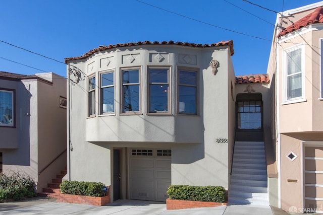 mediterranean / spanish-style home with a garage