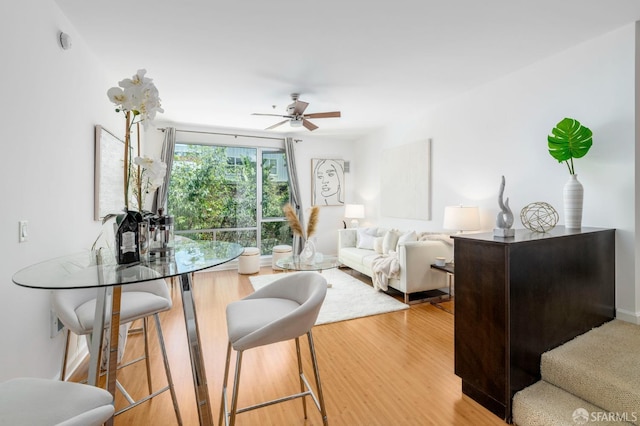 living room with ceiling fan and wood-type flooring