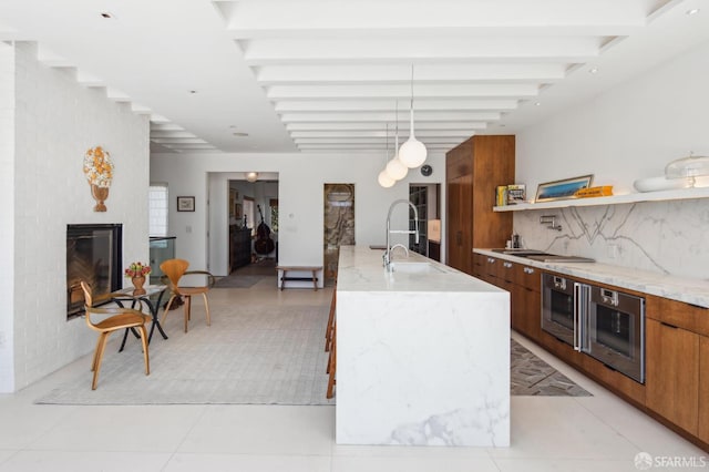 1507 Noe St, San Francisco, CA 94131 - kitchen with modern cabinets, brown cabinets, a sink, beamed ceiling, and pendant lighting