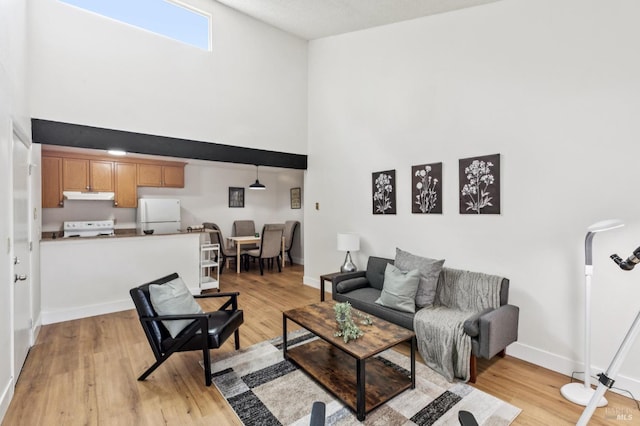 1333 N Camino Alto Unit 227, Vallejo, CA 94589 - living area featuring a high ceiling, light wood finished floors, and baseboards