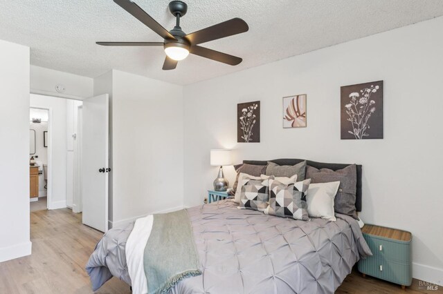 1333 N Camino Alto Unit 227, Vallejo, CA 94589 - bedroom with wood finished floors, a textured ceiling, baseboards, and a ceiling fan