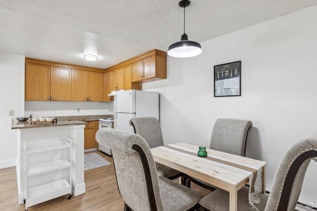 1333 N Camino Alto Unit 227, Vallejo, CA 94589 - dining area featuring light wood-style flooring and a textured ceiling