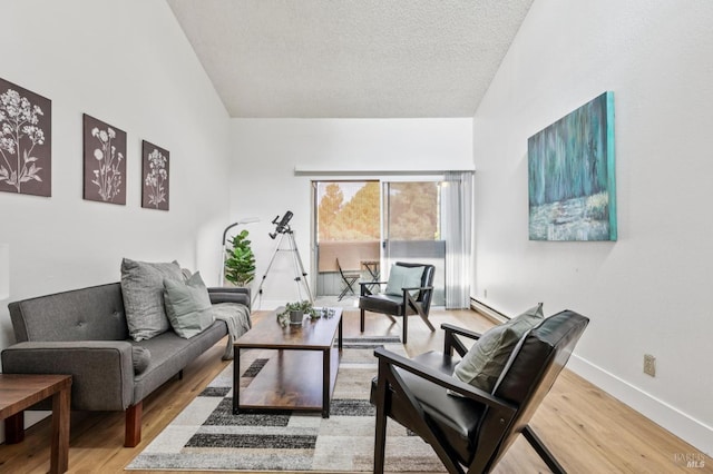 1333 N Camino Alto Unit 227, Vallejo, CA 94589 - living area with lofted ceiling, light wood-style floors, a textured ceiling, baseboards, and a baseboard heating unit