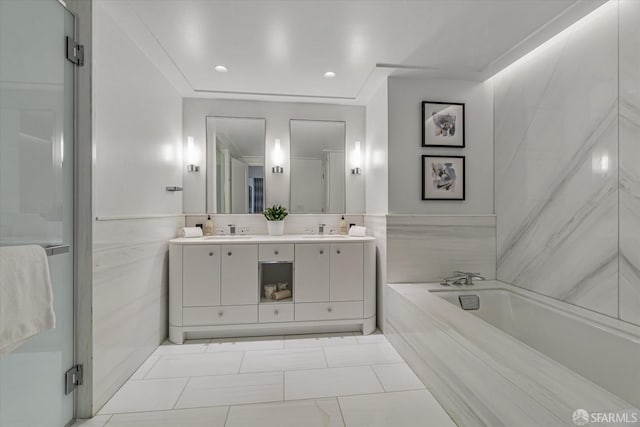 bathroom with vanity and shower with separate bathtub