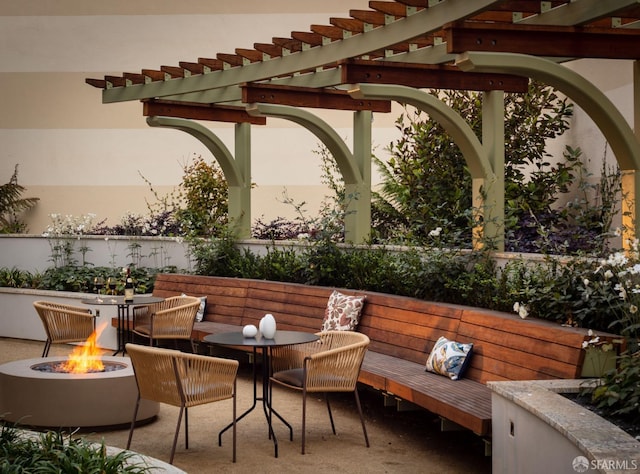 patio terrace at dusk featuring a fire pit