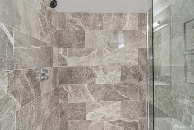 bathroom with tiled shower