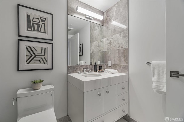 bathroom featuring vanity and toilet