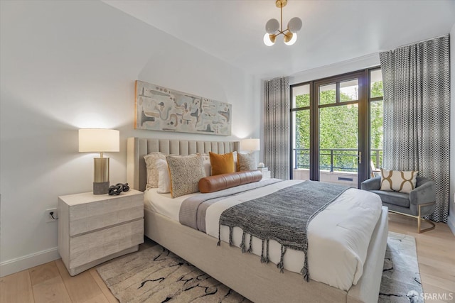 bedroom with a chandelier and light hardwood / wood-style flooring