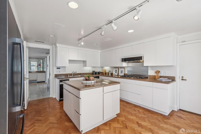 1220 Jones St Unit 601, San Francisco, CA 94109 - kitchen with appliances with stainless steel finishes, a kitchen island, modern cabinets, and white cabinets
