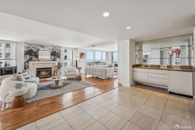 1220 Jones St Unit 601, San Francisco, CA 94109 - living area featuring light tile patterned floors, a glass covered fireplace, and recessed lighting