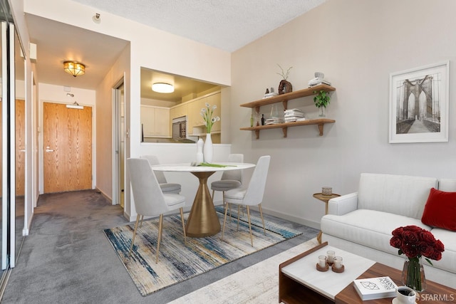 carpeted dining room with a textured ceiling