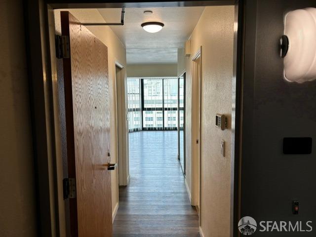 hall with wood-type flooring