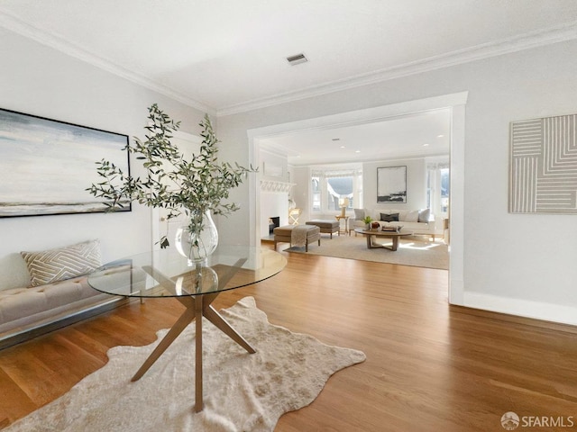 interior space featuring hardwood / wood-style flooring and ornamental molding