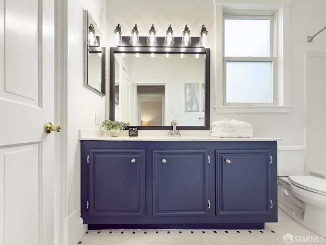 bathroom with vanity, tile patterned floors, and toilet