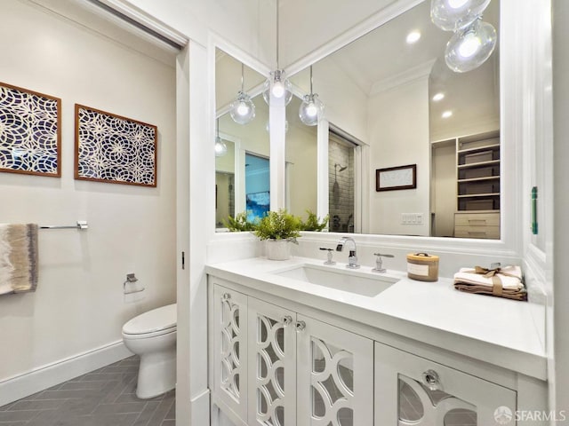 bathroom featuring ornamental molding, toilet, tile patterned flooring, and vanity