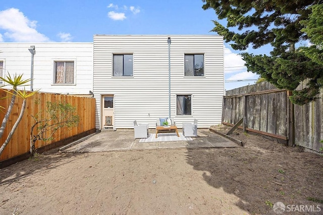 rear view of house featuring a patio area and a fenced backyard