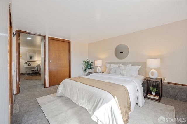 bedroom featuring a closet and light carpet