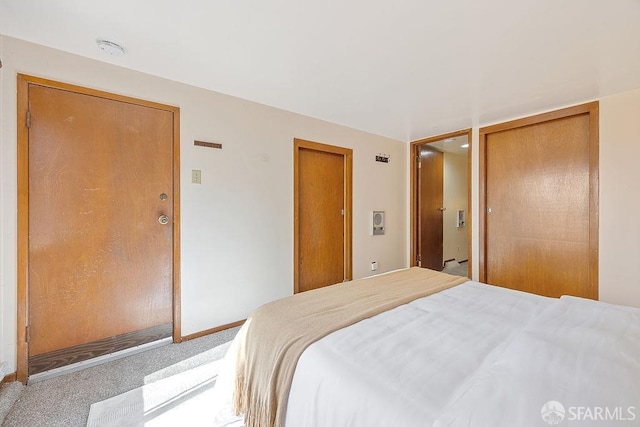 bedroom featuring baseboards and carpet