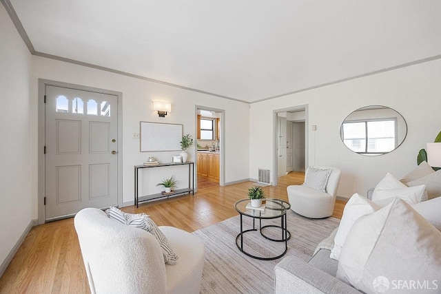 living area with visible vents, plenty of natural light, and light wood-style flooring