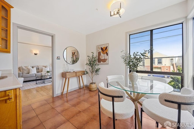 dining room featuring light tile patterned floors and baseboards