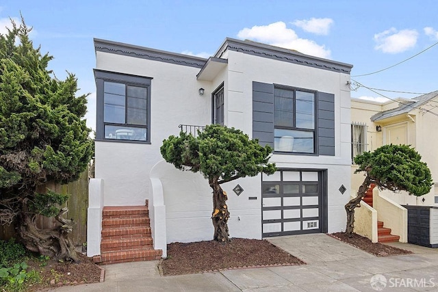 view of front of home featuring stucco siding, concrete driveway, and an attached garage