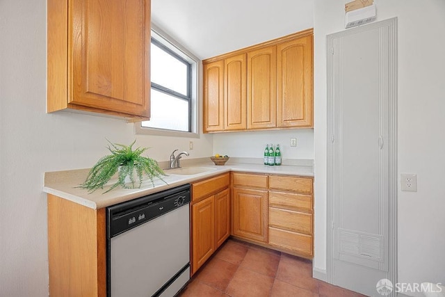 kitchen featuring light countertops, light tile patterned floors, white dishwasher, and a sink