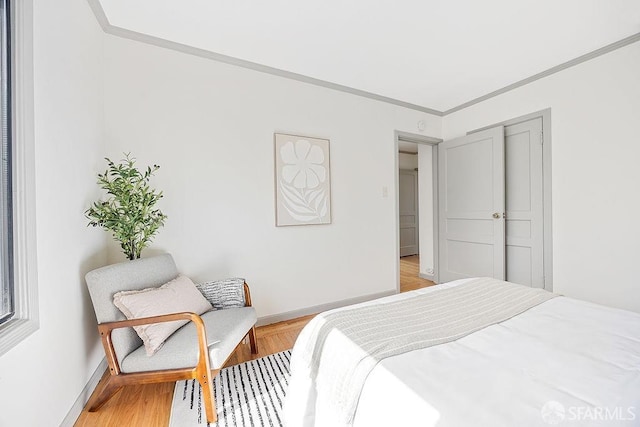 bedroom featuring crown molding and baseboards