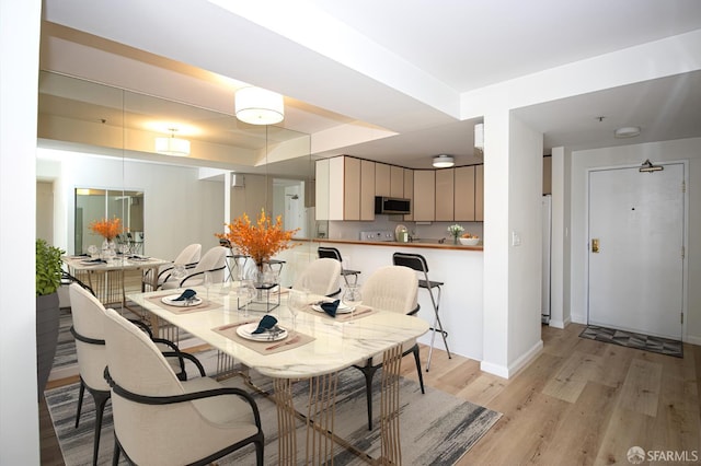 601 Van Ness Ave Unit 712, San Francisco, CA 94102 - dining space featuring light wood-type flooring and a raised ceiling