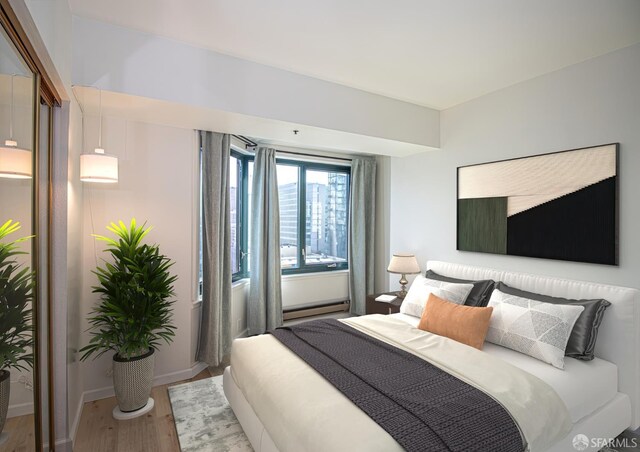 601 Van Ness Ave Unit 712, San Francisco, CA 94102 - bedroom featuring wood finished floors and a baseboard radiator