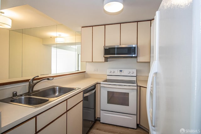 601 Van Ness Ave Unit 712, San Francisco, CA 94102 - kitchen with appliances with stainless steel finishes, light countertops, light wood-type flooring, and cream cabinets