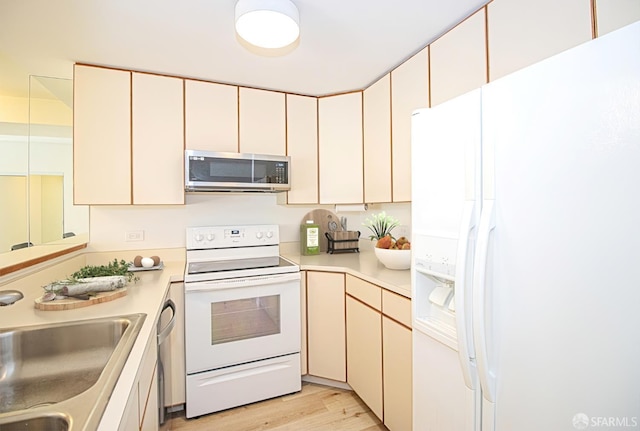 601 Van Ness Ave Unit 712, San Francisco, CA 94102 - kitchen featuring white appliances, light countertops, light wood-style floors, and cream cabinetry