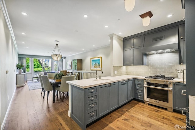 kitchen with kitchen peninsula, gray cabinetry, and pendant lighting