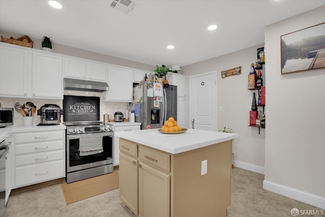 kitchen featuring tasteful backsplash, light countertops, visible vents, appliances with stainless steel finishes, and under cabinet range hood