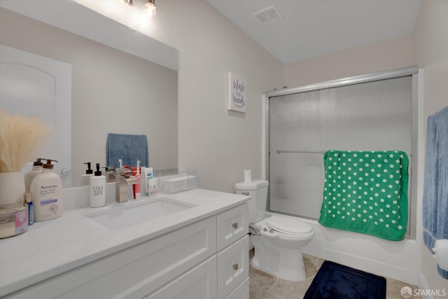 bathroom with visible vents, toilet, shower / bath combination with glass door, tile patterned flooring, and vanity