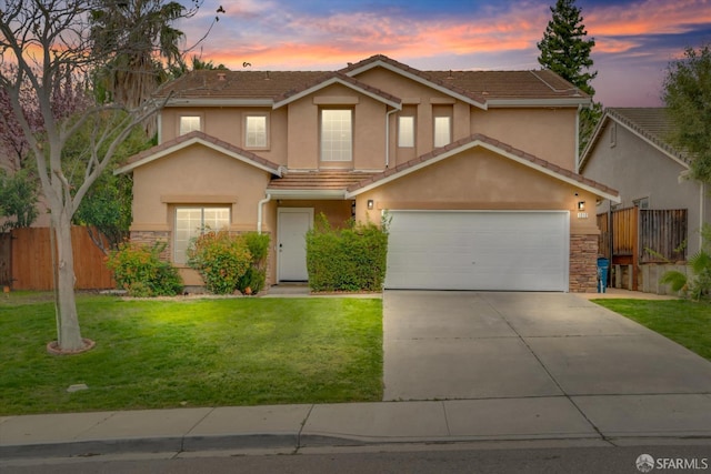 view of front facade with stone siding, a front yard, fence, and stucco siding