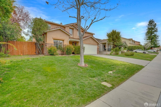 view of front of property with an attached garage, fence, concrete driveway, stucco siding, and a front yard