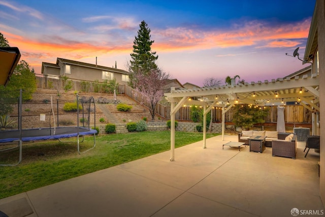 view of patio with a fenced backyard, a trampoline, an outdoor living space, and a pergola