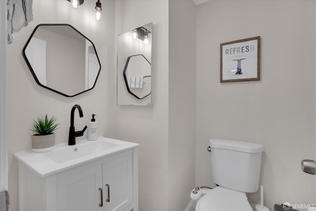 bathroom featuring vanity and toilet