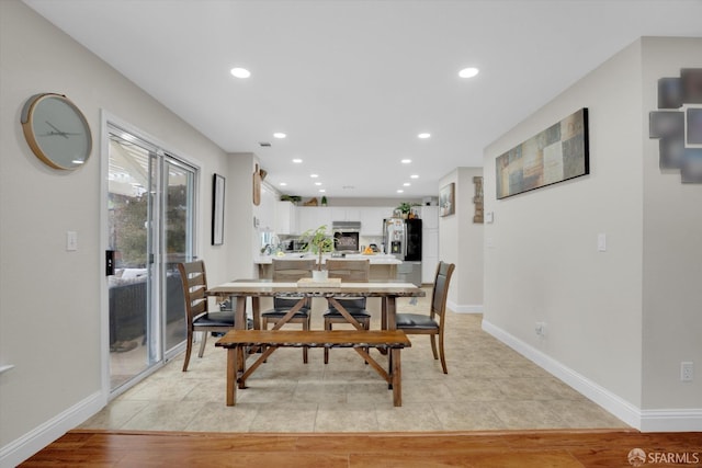 dining area featuring light wood finished floors, baseboards, and recessed lighting