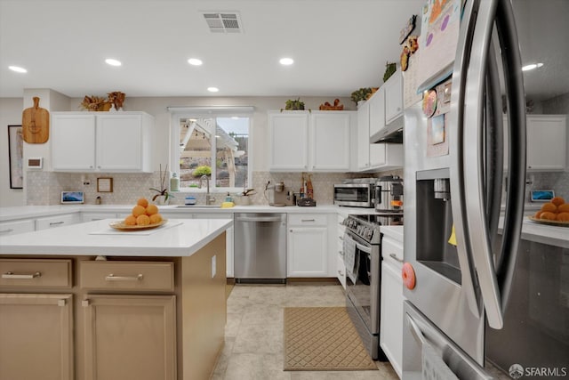 kitchen with visible vents, appliances with stainless steel finishes, light countertops, and backsplash