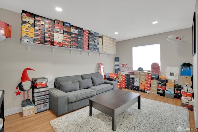 living room with baseboards, wood finished floors, and recessed lighting