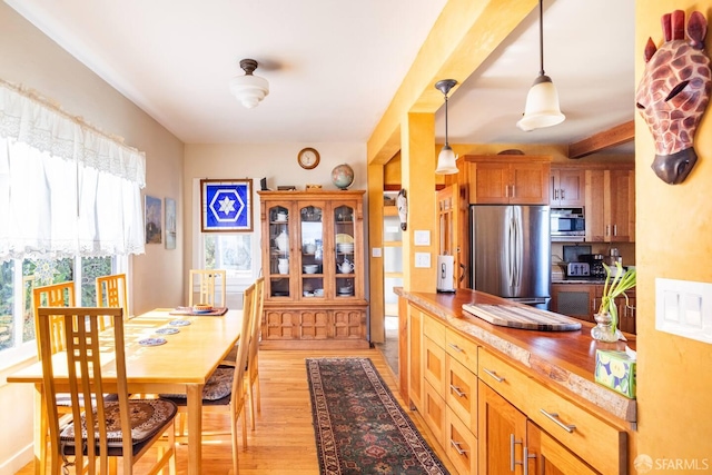 70 Laidley St, San Francisco, CA 94131 - dining room featuring healthy amount of natural light, light wood-style floors, and beam ceiling