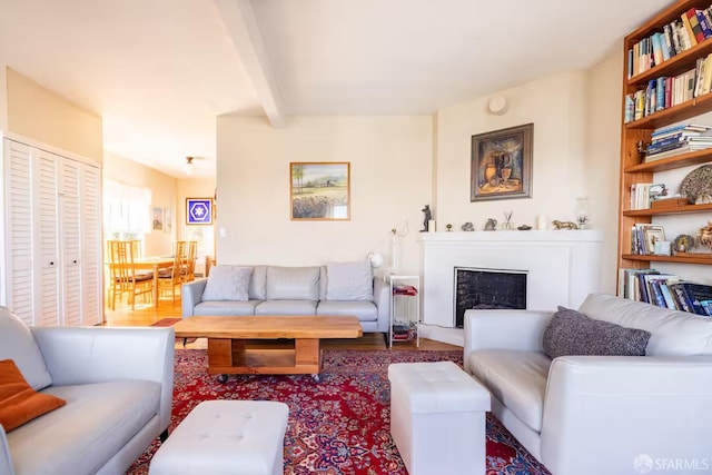 70 Laidley St, San Francisco, CA 94131 - living room with beam ceiling, wood finished floors, and a fireplace with raised hearth