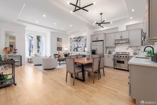 2675 Sutter St, San Francisco, CA 94115 - dining space with a tray ceiling, a chandelier, recessed lighting, light wood finished floors, and crown molding