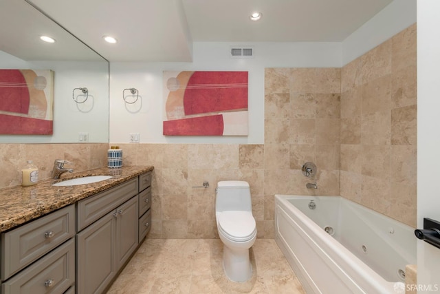 2675 Sutter St, San Francisco, CA 94115 - full bathroom featuring tile walls, vanity, a jetted tub, wainscoting, and recessed lighting